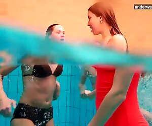 three nude ladies have fun in the water